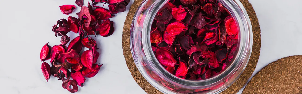 jar filled with deep red flower petals